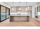 Modern kitchen featuring an island, ample cabinet space, stainless steel appliances, and view to fireplace patio at 3927 Enclave Way, Tucker, GA 30084