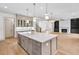 Spacious kitchen with island, stainless steel appliances, and open view to the living room with fireplace at 3927 Enclave Way, Tucker, GA 30084