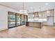 Open concept kitchen with island, bar seating, stainless steel appliances, and a view to a patio at 3927 Enclave Way, Tucker, GA 30084