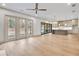 Open-concept living area with wood floors, fireplace, and sliding glass doors to the outdoors, flowing into the kitchen at 3927 Enclave Way, Tucker, GA 30084