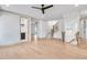 Spacious living room with hardwood floors, white walls, and entry to laundry, stairs, and other rooms at 3927 Enclave Way, Tucker, GA 30084