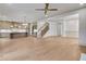 Spacious living and kitchen area featuring wood floors, neutral walls, and staircase at 3927 Enclave Way, Tucker, GA 30084
