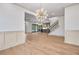 Open-concept living area with hardwood floors, modern lighting, and seamless flow to other spaces at 3927 Enclave Way, Tucker, GA 30084