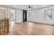 Spacious living room featuring hardwood floors, a ceiling fan, two windows and a built-in bookcase at 3927 Enclave Way, Tucker, GA 30084