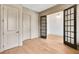 Spacious office featuring wood floors, multiple doorways and windows, and neutral paint tones at 3927 Enclave Way, Tucker, GA 30084