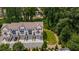 Aerial view showcases the townhome's facade with a driveway, garage, and lush green surroundings at 4524 Mikajack Se Dr, Smyrna, GA 30080
