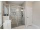 Modern bathroom featuring a glass enclosed shower with marble tiling and a white tiled floor at 4524 Mikajack Se Dr, Smyrna, GA 30080