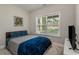 Bright bedroom with a large window, soft carpet, and comfortable bed with blue bedding at 4524 Mikajack Se Dr, Smyrna, GA 30080