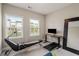 Cozy room with home gym equipment, a large mirror, and ample natural light from two windows at 4524 Mikajack Se Dr, Smyrna, GA 30080