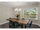 Dining room features hardwood floors, modern chandelier, and large window views at 4524 Mikajack Se Dr, Smyrna, GA 30080