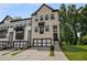 View of the stylish townhome with a two-car garage and brick facade at 4524 Mikajack Se Dr, Smyrna, GA 30080