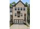 Charming townhome with a modern two-car garage and brick facade at 4524 Mikajack Se Dr, Smyrna, GA 30080