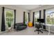 Bright home office space with a large window, love seat, and modern desk setup at 4524 Mikajack Se Dr, Smyrna, GA 30080