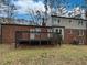 Backyard featuring a brick home and a wooden deck at 6390 E Stubbs Rd, Atlanta, GA 30349