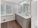 Bathroom featuring a double sink vanity with a marble countertop and modern fixtures at 6390 E Stubbs Rd, Atlanta, GA 30349