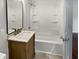 Bathroom featuring a tub-shower combination with a single vanity, a mirror, and a tile floor at 6390 E Stubbs Rd, Atlanta, GA 30349