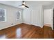 Bedroom featuring hardwood floors, natural light from windows, and a double door closet at 6390 E Stubbs Rd, Atlanta, GA 30349