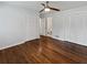 Cozy bedroom featuring two closet doors, hardwood floors, a ceiling fan, and access to a bathroom at 6390 E Stubbs Rd, Atlanta, GA 30349