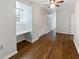 A well-lit bedroom featuring a ceiling fan, built-in desk, and closet at 6390 E Stubbs Rd, Atlanta, GA 30349