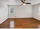 A spacious bedroom featuring a ceiling fan, hardwood floors, and natural light at 6390 E Stubbs Rd, Atlanta, GA 30349
