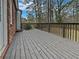 Spacious wooden deck providing an outdoor living area and views of the backyard and surrounding landscape at 6390 E Stubbs Rd, Atlanta, GA 30349
