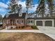Charming brick home with a well-manicured lawn and an attached two-car garage at 6390 E Stubbs Rd, Atlanta, GA 30349