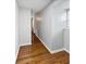 Hallway showcasing hardwood floors and neutral paint, creating a seamless transition between rooms at 6390 E Stubbs Rd, Atlanta, GA 30349