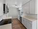 A bright kitchen featuring modern appliances, white cabinets, and hardwood floors at 6390 E Stubbs Rd, Atlanta, GA 30349