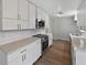 Bright kitchen with stainless steel appliances, white cabinets, and solid surface countertops at 6390 E Stubbs Rd, Atlanta, GA 30349