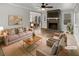 Bright living room with a brick fireplace, ceiling fan, and wood floors at 6390 E Stubbs Rd, Atlanta, GA 30349