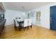 Dining area with hardwood floors, modern light fixtures, and windows, creating a bright and airy atmosphere at 2167 Tully Wren Ne, Marietta, GA 30066