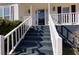 Inviting front porch with freshly painted black stairs and white railings, leading to a glass-paneled front door at 2167 Tully Wren Ne, Marietta, GA 30066