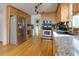 Bright kitchen featuring stainless steel appliances, light wood cabinetry, granite countertops, and sleek hardwood floors at 2167 Tully Wren Ne, Marietta, GA 30066