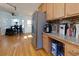 Open kitchen area with stainless steel appliances, granite countertops, and hardwood floors leading to a casual dining area at 2167 Tully Wren Ne, Marietta, GA 30066