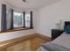 Bright main bedroom featuring hardwood floors, a window seat, and gray curtains at 2167 Tully Wren Ne, Marietta, GA 30066