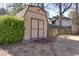 Outdoor storage shed nestled in the backyard against a wooded treeline at 2167 Tully Wren Ne, Marietta, GA 30066