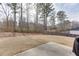 Backyard with a grass lawn, privacy fence, and trees at 3410 Summerpoint Xing, Cumming, GA 30028