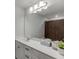 Bathroom featuring a spacious countertop, a large mirror, and sleek fixtures at 3410 Summerpoint Xing, Cumming, GA 30028