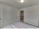 A neutral bedroom features a doorway and a bed with stripped bedding at 3410 Summerpoint Xing, Cumming, GA 30028