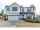 Charming two-story home with white siding, a covered porch, and a two-car garage at 3410 Summerpoint Xing, Cumming, GA 30028