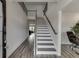 Bright foyer featuring hardwood floors, a staircase with dark banister, and high ceilings at 3410 Summerpoint Xing, Cumming, GA 30028