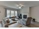 Cozy living room featuring a fireplace, gray furniture, and a ceiling fan at 3410 Summerpoint Xing, Cumming, GA 30028