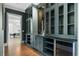 An elegant bar area with custom cabinetry, display shelves, and wine storage at 42 Blackland Nw Rd, Atlanta, GA 30342