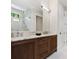 Bathroom with a double sink, wood cabinets, marble countertop and backsplash, and a large mirror at 42 Blackland Nw Rd, Atlanta, GA 30342