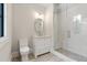 White bathroom featuring tile floors, vanity with round mirror, and a glass-enclosed shower with subway tile at 42 Blackland Nw Rd, Atlanta, GA 30342