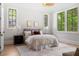 A cozy bedroom with natural light, neutral color palette, hardwood floors, and modern decor at 42 Blackland Nw Rd, Atlanta, GA 30342