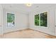 Spacious bedroom with hardwood floors, neutral paint, recessed lighting, and two windows showcasing outside greenery at 42 Blackland Nw Rd, Atlanta, GA 30342