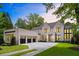 Elegant, all white brick home with black window frames, three-car garage, and professionally landscaped front yard at 42 Blackland Nw Rd, Atlanta, GA 30342