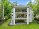 Aerial view of modern three-story home with balconies, a well-manicured lawn, and lush landscaping at 42 Blackland Nw Rd, Atlanta, GA 30342