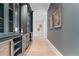 Long hallway featuring a drink station with navy blue cabinets, granite countertops, and light wood flooring at 42 Blackland Nw Rd, Atlanta, GA 30342